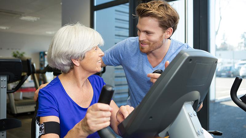 therapist with senior woman exercising